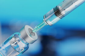 Medical disposable syringe for vaccine injection and glass vial.