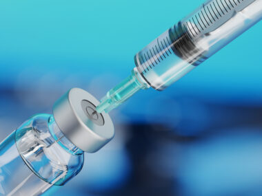 Medical disposable syringe for vaccine injection and glass vial.