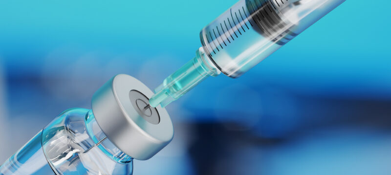 Medical disposable syringe for vaccine injection and glass vial.