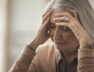 Senior Caucasian woman holding her forehead