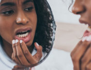 Young,African,American,Woman,Looking,At,Mirror,While,Suffering,From