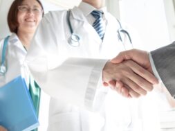 Doctor and business people shaking hands