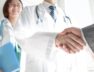 Doctor and business people shaking hands